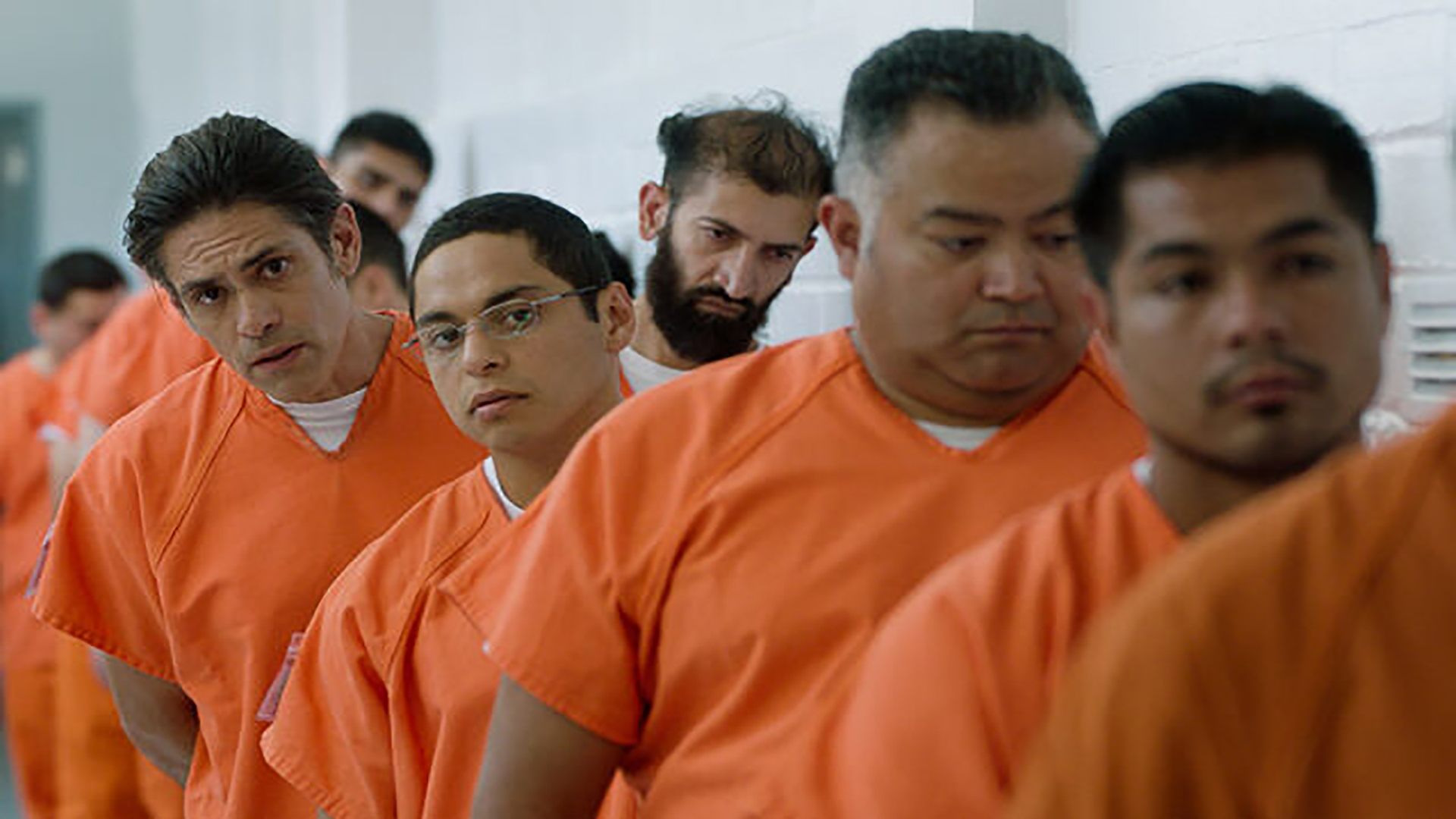 Infiltrators: People lined up in orange shirts