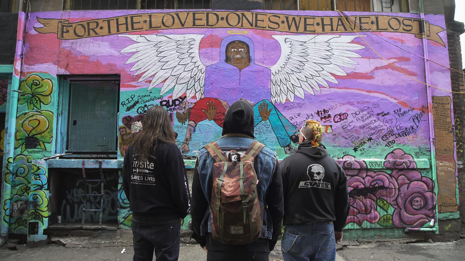 members view a mural of an angel during a scene from Love in the Time of Fentanyl, a documentary about frontline harm reduction workers in Vancouver.