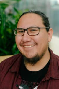 Headshot of Damien EB, director of the documentary Skoden.
