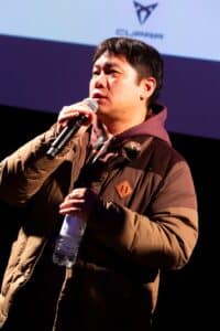 Director Kim Mooyoung speaking on stage at a screening of The Sense of Violence.